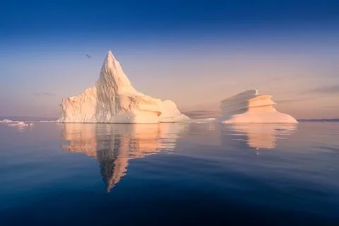 Floating glaciers in the rays of the setting sun at polar night Stock Photos