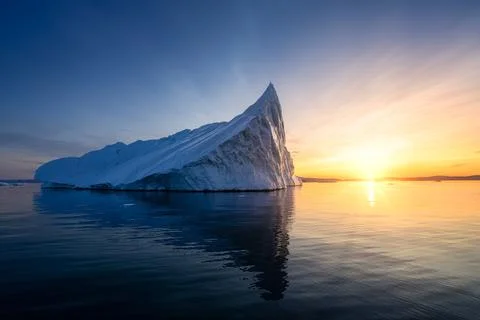 Floating glaciers in the rays of the setting sun at polar night Stock Photos