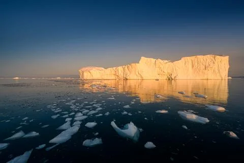 Floating glaciers in the rays of the setting sun at polar night Stock Photos