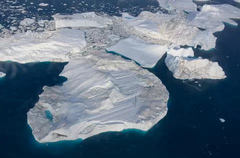 Floating glaciers in the rays of the setting sun at polar night Stock Photos