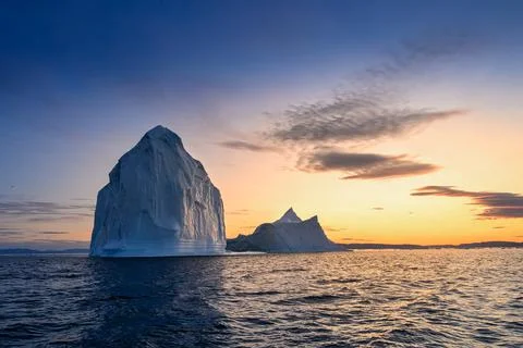 Floating glaciers in the rays of the setting sun at polar night Stock Photos