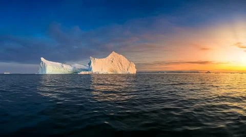 Floating glaciers in the rays of the setting sun at polar night Stock Photos