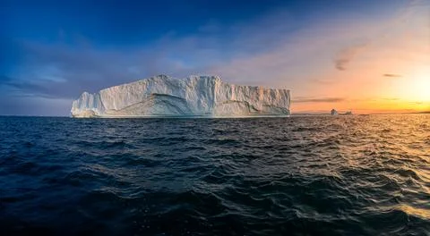 Floating glaciers in the rays of the setting sun at polar night Stock Photos