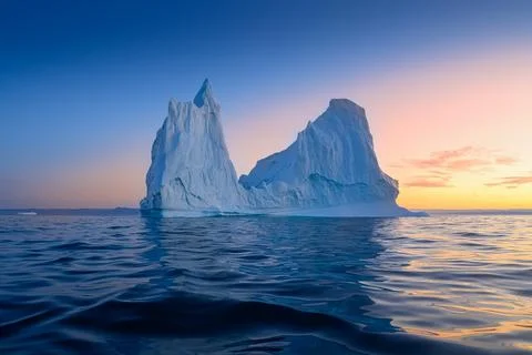 Floating glaciers in the rays of the setting sun at polar night Stock Photos