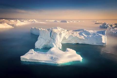 Floating glaciers in the rays of the setting sun during a polar night Stock Photos