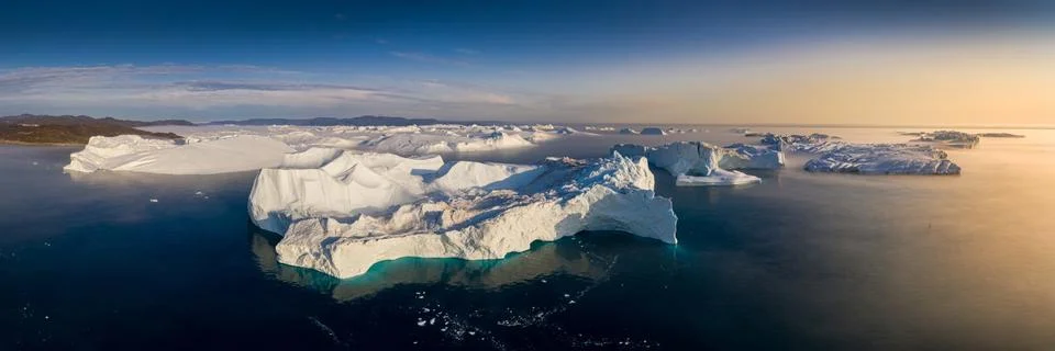 Floating glaciers in the rays of the setting sun during a polar night Stock Photos