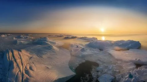 Floating glaciers in the rays of the setting sun during a polar night Stock Photos