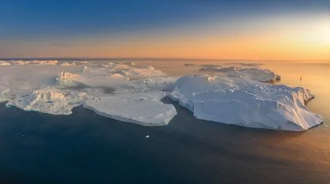 Floating glaciers in the rays of the setting sun during a polar night Stock Photos