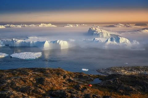 Floating glaciers in the rays of the setting sun during a polar night Stock Photos