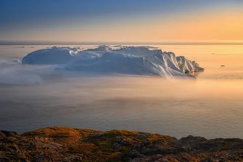 Floating glaciers in the rays of the setting sun during a polar night Stock Photos