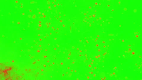 Floating glowing orange particles drifting against a bright green screen Stock Footage 338388312