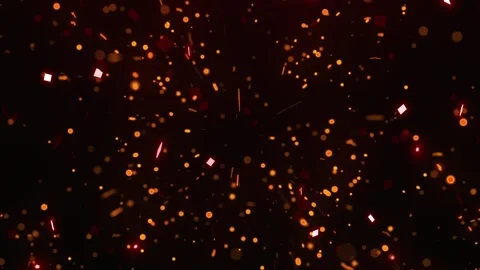 Floating golden confetti particles drifting through dark space background 動画素材 338387327
