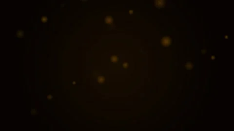 Floating golden light particles shimmering against a deep black background Video stock 339618769