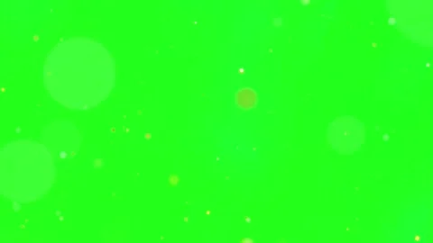 Floating golden particles rising against bright green screen background for Stockbeeldmateriaal 344635337