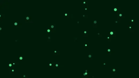 Floating green particles scattered across a solid black background space Video stock 335117912