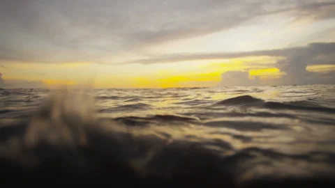 Floating Half in and half out of the water with sunset Stock Footage 111840645