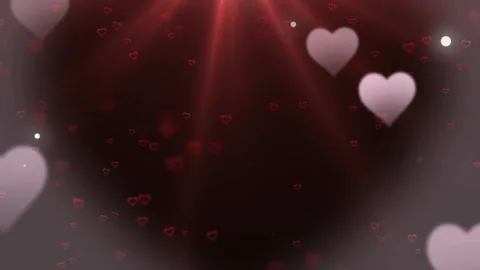 Floating heart particles rising against dark red background with soft glowing Vidéo 345102185