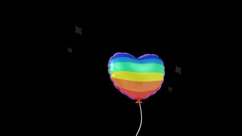 Floating Heart Shaped Balloon Painted with Colorful Rainbow Stripes. Stock Footage 340283452