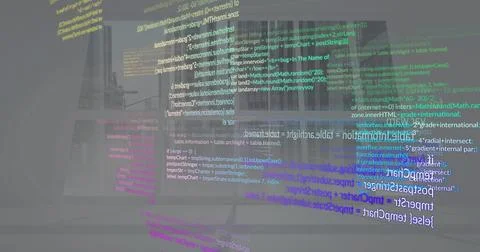 Floating holographic code streams rising above laptop computer at office desk, Foto stock