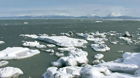 Floating Ice Chunks in Bay Mountains Beyond Stock Footage 10841775