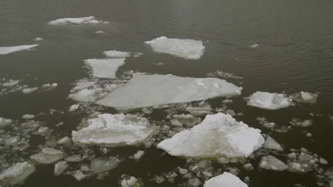 Floating Ice Floes and Broken River Ice Drifting on Dark Winter Water Surface. Stock Footage 330645321