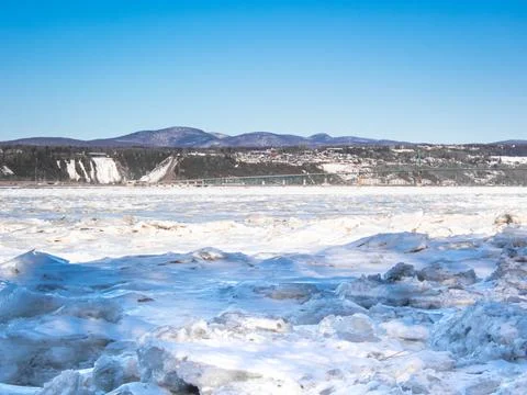 Floating ice on St-Lawrence river with a view of Orlean's island bridge and.. Stock Photos