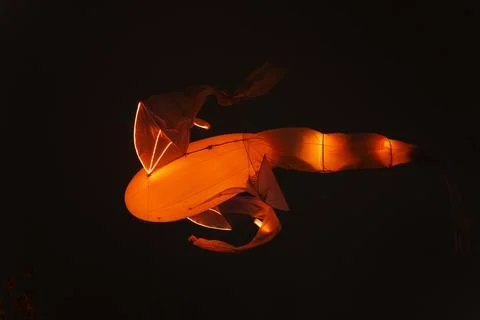 Floating illuminated structure with smooth orange body Foto stock