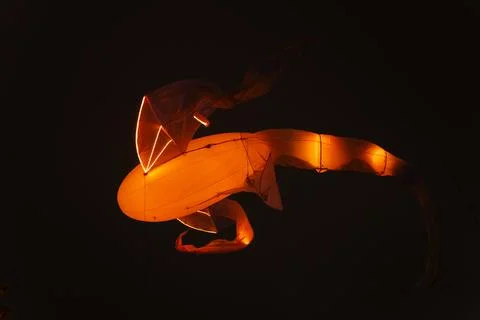Floating illuminated structure with smooth orange body Stock Photos