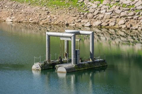 Floating intake pontoon pumping station in water reservoir Asturias Spain Fotos Stock