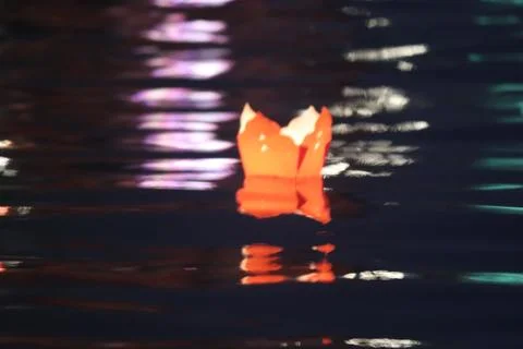 Floating Lantern on Water with Reflections Stock Photos