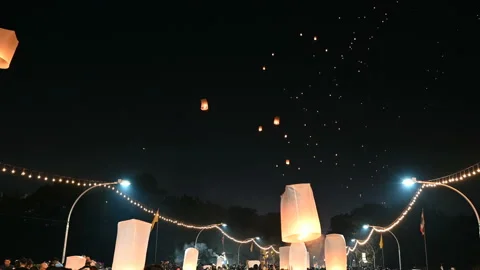 Floating lanterns in the night sky. Launching Sky Lantern. Yee Peng Festival, Lo Stock Footage 155224655