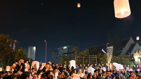 Floating lanterns in the night sky. Launching Sky Lantern. Yee Peng Festival, Lo Stock Footage 155580436