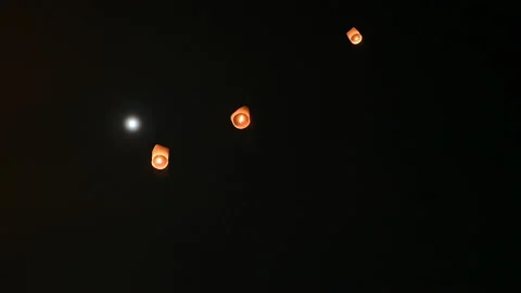 Floating lanterns in the night sky. Launching Sky Lantern. Yee Peng Festival, Lo Stock Footage 160674677