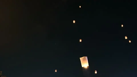 Floating lanterns in the night sky. Launching Sky Lantern. Yee Peng Festival, Lo Stock Footage 163149027