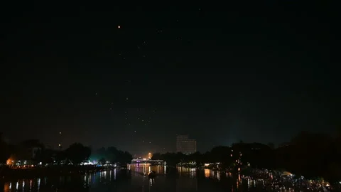 Floating lanterns in the night sky. Launching Sky Lantern. Yee Peng Festival, Lo Stock Footage 163653897