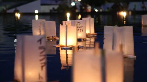 Floating lanterns on water during Obon festival night ceremony and remembrance Stock Footage 331565052