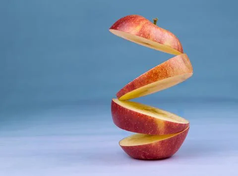 Floating levitating ripe apple on blue background. Vitamins, healthy diet con Stock-Fotos