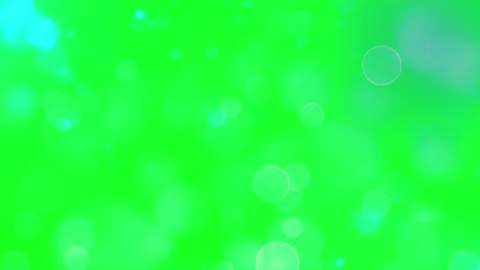 Floating light bokeh particles moving on a vibrant green chroma key background Stock Footage 345807185