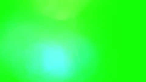 Floating luminous light orbs moving across vibrant green screen background for Видео 344416880