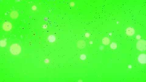 Floating luminous particles and soft bokeh circles over vibrant green screen Video stock 345330936
