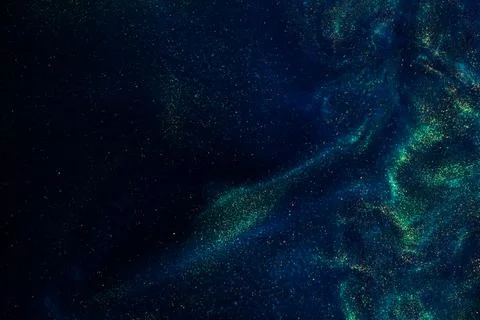 Floating Magic Gold Particles In Blue Fluid. Stock-Fotos