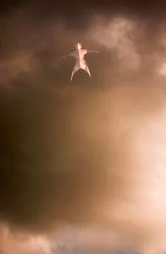 Floating man figure in clouds Stock Photos