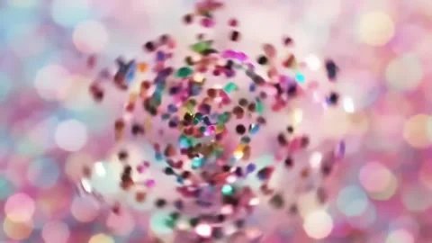 Floating Multi-Colored Confetti Particles Against Soft Pink Blurred Backgroun Stock Footage 313348712