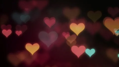Floating multicolored heart bokeh shapes drifting slowly across dark pink Video stock 342108289