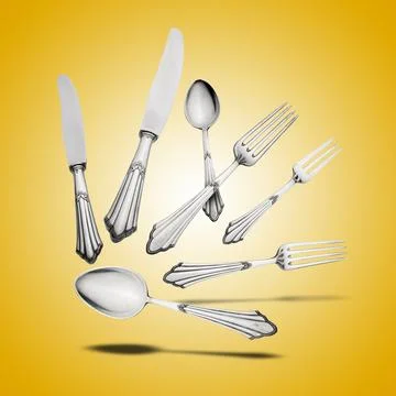 Floating Old Silverware Set  with shadows on orange gradient Stock Photos