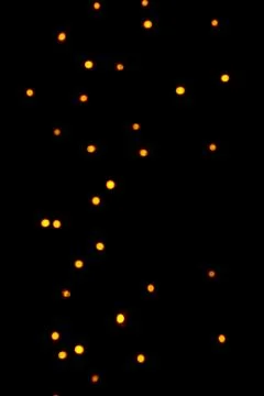 Floating orange lantern light bokeh glowing softly against a black night Stock Illustration