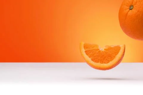 Floating oranges isolated on an orange and white background Stock Photos