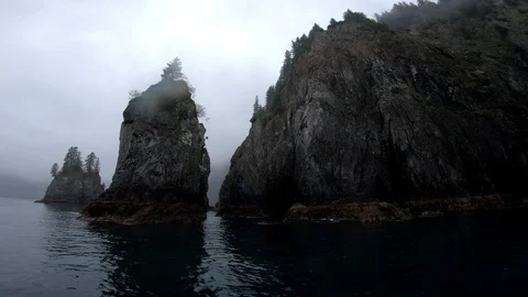 Floating past rock cliffs in Alaskan Fjord Stock Footage 113606125
