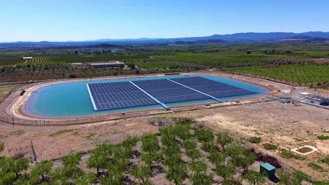 Floating photovoltaic array installed on an irrigation reservoir surrounded by Stock-Footage 332942298