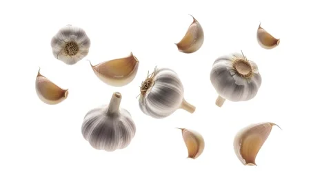Floating pieces of garlic isolated on white Stock Footage 339340660
